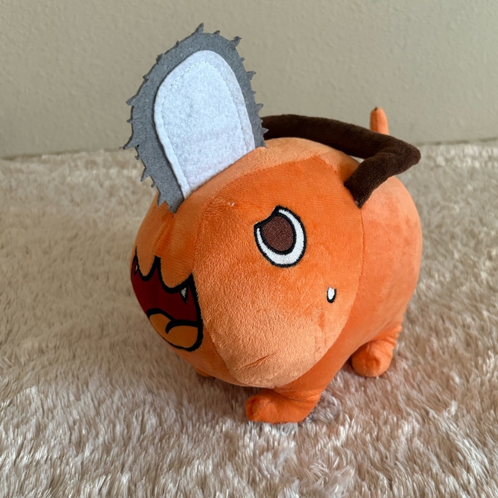 Orange Plush Toy with Chainsaw Design